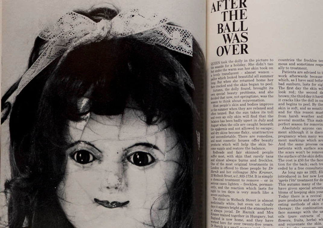 Open book with a black and white illustration of a doll's face on the left page and text on the right page.