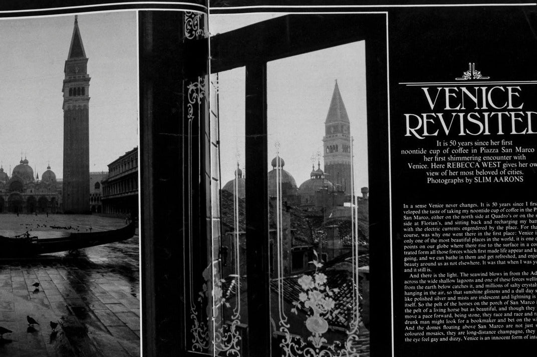 An open vintage magazine or book spread showing a black-and-white photograph of Venice with gondolas and the Campanile, alongside an article titled 'Venice Revisited' with decorative borders.