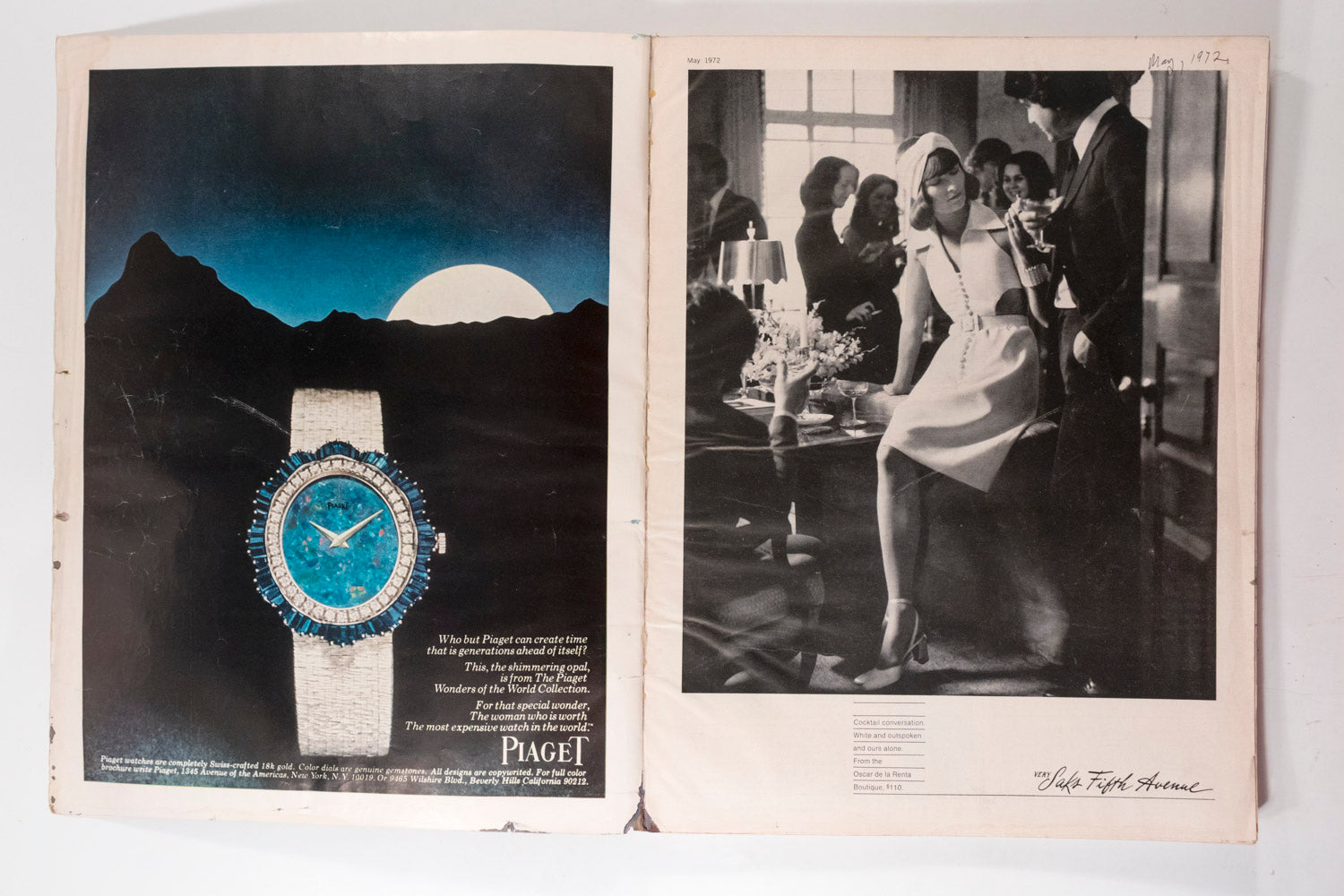 An open vintage magazine or book spread showing a Piaget advertisement. The left page features a wristwatch with a blue dial and blue crystal embellishments on a white strap, set against a dark mountain landscape with a full moon.